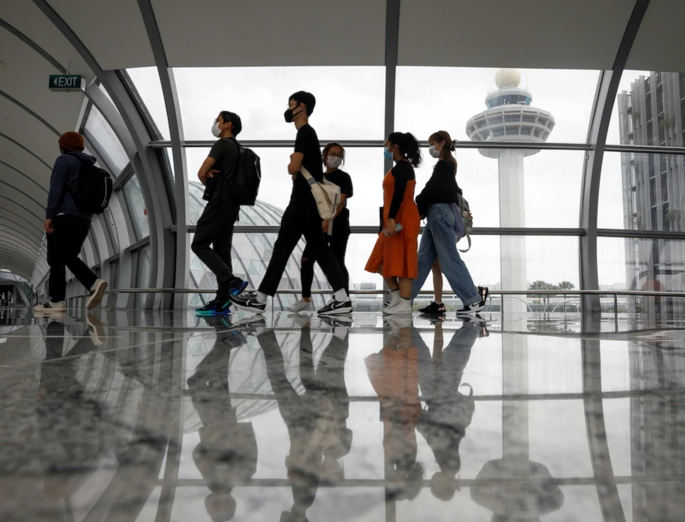 People pass the control tower of Singapore’s Changi Airport, Singapore January 18, 2021. ― Reuters pic
