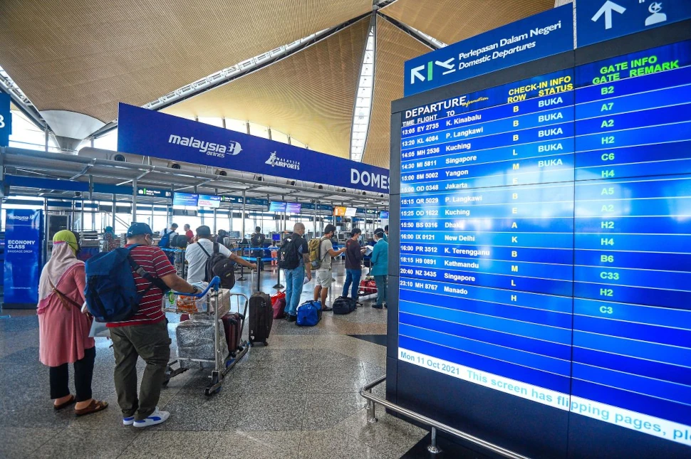 Passengers queing up to check in at service counter at KLIA main terminal. - Filepic by AZHAR MAHFOF/The Star